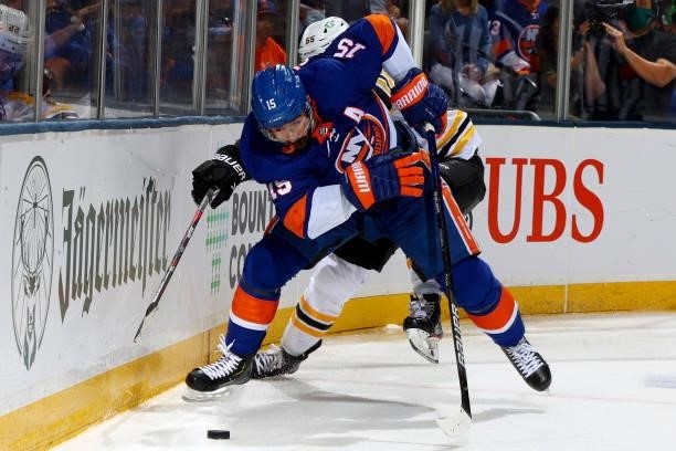 Cal Clutterbuck of the New York Islanders handles the puck against Jeremy Lauzon of the Boston Bruins during the third period in Game Four of the...