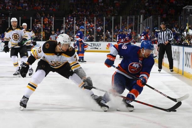 Anthony Beauvillier of the New York Islanders handles the puck against Charlie McAvoy of the Boston Bruins during the third period in Game Four of...