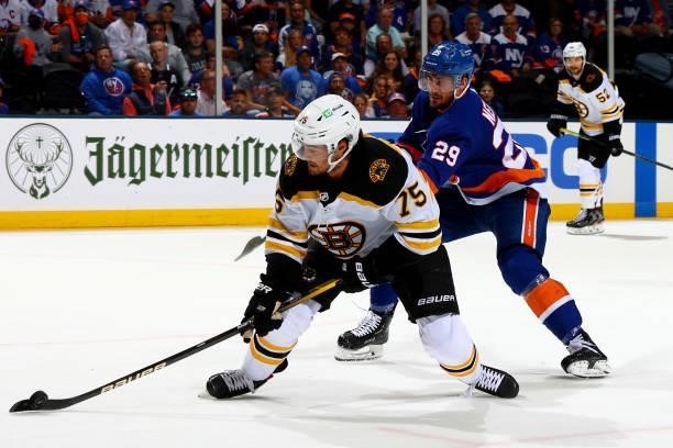 Connor Clifton of the Boston Bruins handles the puck against Brock Nelson of the New York Islanders during the third period in Game Four of the...