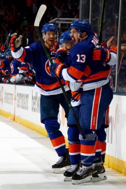 Mathew Barzal of the New York Islanders celebrates with Jordan Eberle and Scott Mayfield after scoring a goal against the Boston Bruins during the...