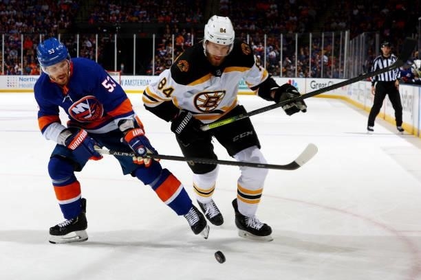 Casey Cizikas of the New York Islanders and Jarred Tinordi of the Boston Bruins compete for the puck during the second period in Game Four of the...