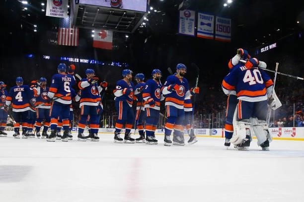 The New York Islanders celebrate with Semyon Varlamov after their 4-1 win against the Boston Bruins in Game Four of the Second Round of the 2021...