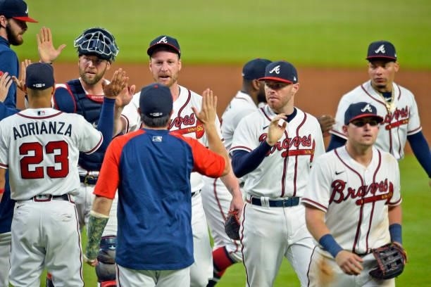 Kevan Smith, Will Smith, Freddie Freeman and Austin Riley of the Atlanta Braves walk off the field after beating the Los Angeles Dodgers 6-4 at...