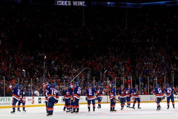 The New York Islanders celebrate their 4-1 win over the Boston Bruins in Game Four of the Second Round of the 2021 Stanley Cup Playoffs at Nassau...
