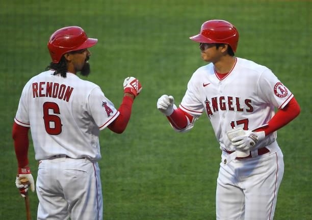 Shohei Ohtani of the Los Angeles Angels is congratulated by Anthony Rendon after hitting a solo home run in the first inning of the game against the...