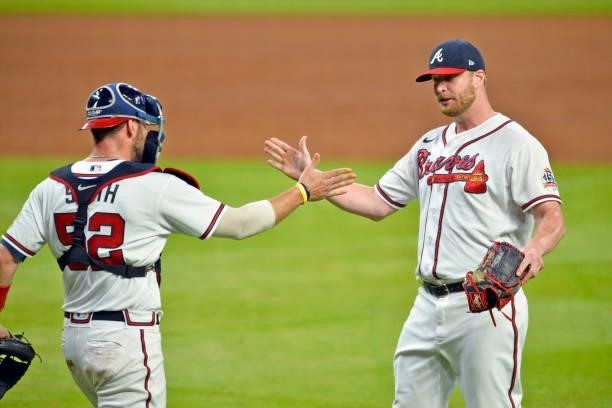 Kevan Smith and Will Smith of the Atlanta Braves high five after defeating the Los Angeles Dodgers 6-4 at Truist Park on June 5, 2021 in Atlanta,...