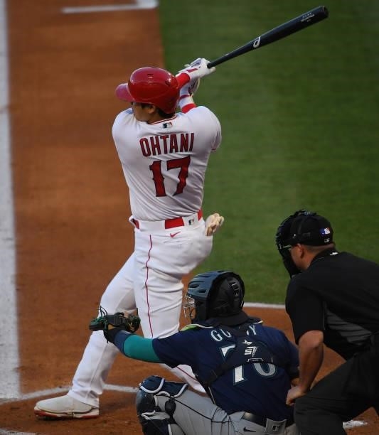 Shohei Ohtani of the Los Angeles Angels hits a solo home run in the first inning of the game against the Seattle Mariners at Angel Stadium of Anaheim...