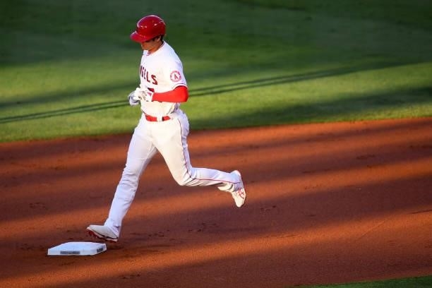 Shohei Ohtani of the Los Angeles Angels rounds the bases after hitting a solo home run in the first inning of the game against the Seattle Mariners...