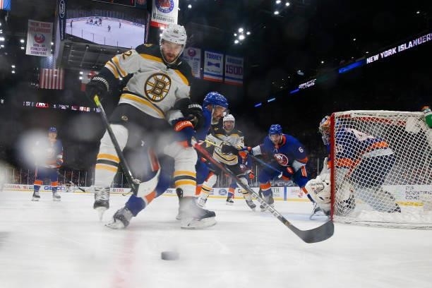 Sean Kuraly of the Boston Bruins handles the puck against Andy Greene of the New York Islanders during the third period in Game Four of the Second...