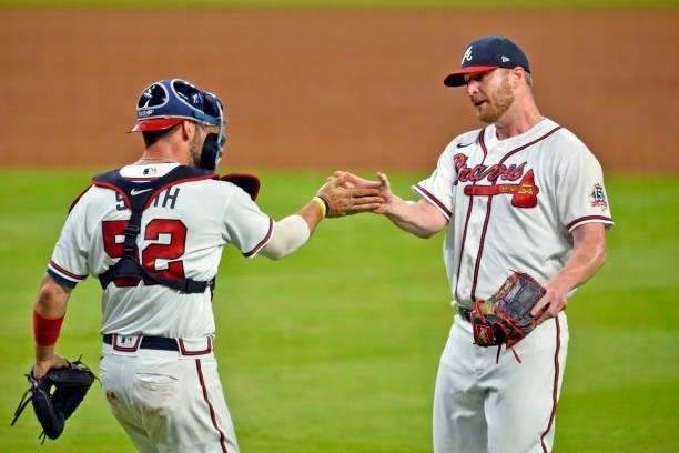 Kevan Smith and Will Smith of the Atlanta Braves high five after defeating the Los Angeles Dodgers 6-4 at Truist Park on June 5, 2021 in Atlanta,...