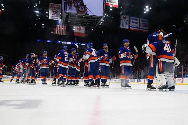 The New York Islanders celebrate with Semyon Varlamov after their 4-1 win against the Boston Bruins in Game Four of the Second Round of the 2021...