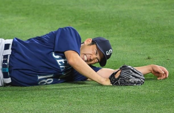 Yusei Kikuchi of the Seattle Mariners reacts on the field after he was hit by a line drive hit by David Fletcher of the Los Angeles Angels in the...