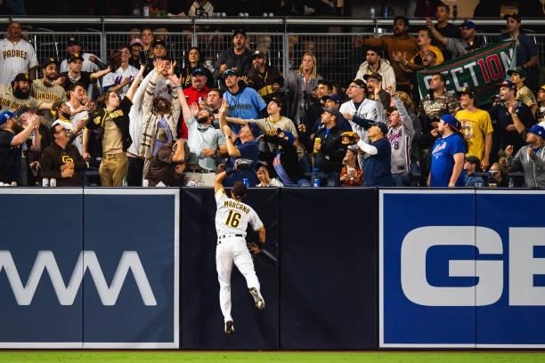 Fans reach for the home run hit by José Peraza of the New York Mets against the San Diego Padres in the fifth inning at Petco Park on June 5, 2021 in...