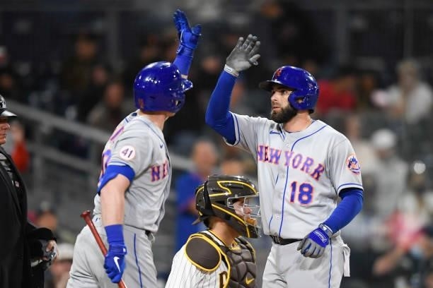 Jose Peraza of the New York Mets is congratulated by Billy McKinney after hitting a solo home run during the fifth inning of a baseball game against...