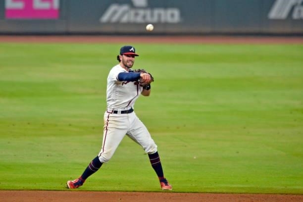 Dansby Swanson of the Atlanta Braves throws to first base to close out the top of the eight inning against the Los Angeles Dodgers at Truist Park on...