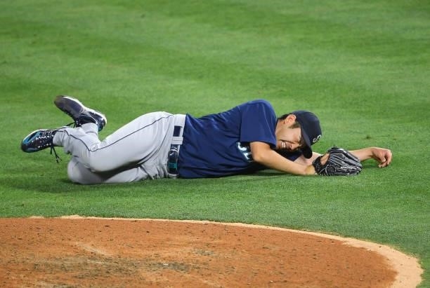 Yusei Kikuchi of the Seattle Mariners reacts on the field after he was hit by a line drive hit by David Fletcher of the Los Angeles Angels in the...