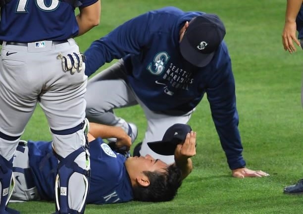 Yusei Kikuchi of the Seattle Mariners receives medical attention on the field after he was hit by a line drive by David Fletcher of the Los Angeles...