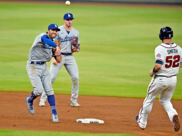Chris Taylor of the Los Angeles Dodgers turns a double play to end the eighth inning against the Atlanta Braves at Truist Park on June 5, 2021 in...