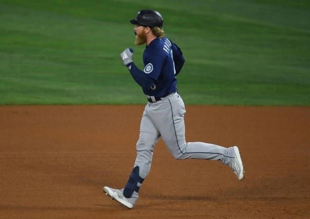 Jake Fraley of the Seattle Mariners rounds the bases after hitting a grand slam home run in the fourth inning of the game against the Los Angeles...
