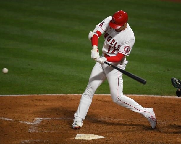 Shohei Ohtani of the Los Angeles Angels hits a sacrifice fly in the seventh inning of the game against the Seattle Mariners at Angel Stadium of...