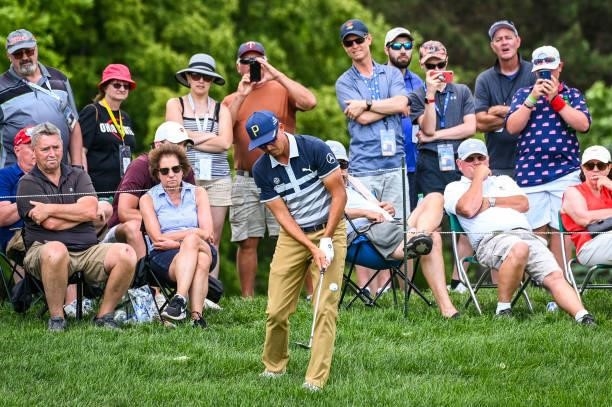 Rickie Fowler chips a shot from the rough on the 10th hole as fans watch during the third round of the Memorial Tournament presented by Nationwide at...