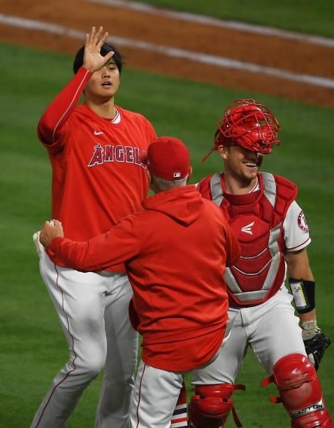 Shohei Ohtani of the Los Angeles Angels celebrates with manager Joe Maddon as Max Stassi laughs after the final out of the ninth inning against the...