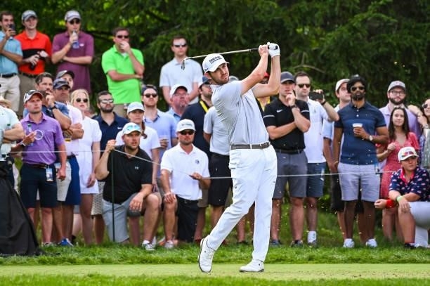 Patrick Cantlay follows through as he plays his shot from the 16th tee while fans watch during the third round of the Memorial Tournament presented...