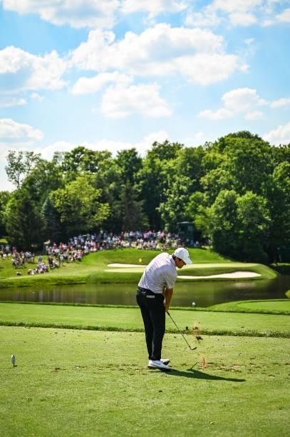 Scottie Scheffler makes impact as he plays his shot from the 12th tee during the third round of the Memorial Tournament presented by Nationwide at...