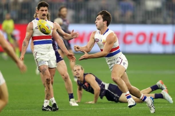 Rhylee West of the Bulldogs handpasses the ball during the 2021 AFL Round 12 match between the Fremantle Dockers and the Western Bulldogs at Optus...