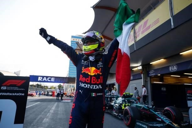 Red Bull's Mexican driver Sergio Perez celebrates after winning the Formula One Azerbaijan Grand Prix at the Baku City Circuit in Baku on June 6,...