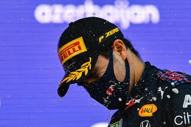 Red Bull's Mexican driver Sergio Perez celebrates on the podium after winning the Formula One Azerbaijan Grand Prix at the Baku City Circuit in Baku...