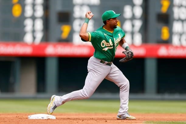 Shortstop Elvis Andrus of the Oakland Athletics throws to first base to complete the double play to end the first inning at Coors Field on June 6,...