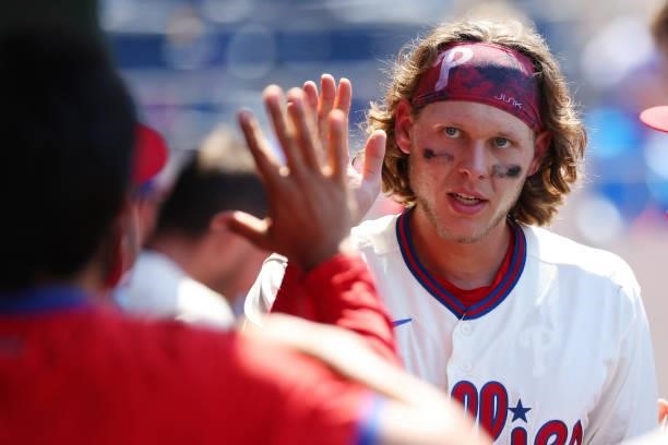 Alec Bohm of the Philadelphia Phillies is congratulated after scoring on a single by Odubel Herrera during the fourth inning of a game against the...