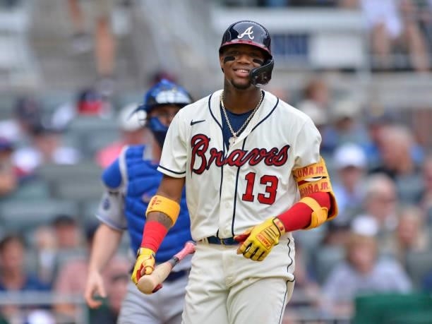 Ronald Acuña Jr. #13 of the Atlanta Braves reacts to a strikeout in the bottom of the 3rd inning against the Los Angeles Dodgers at Truist Park on...