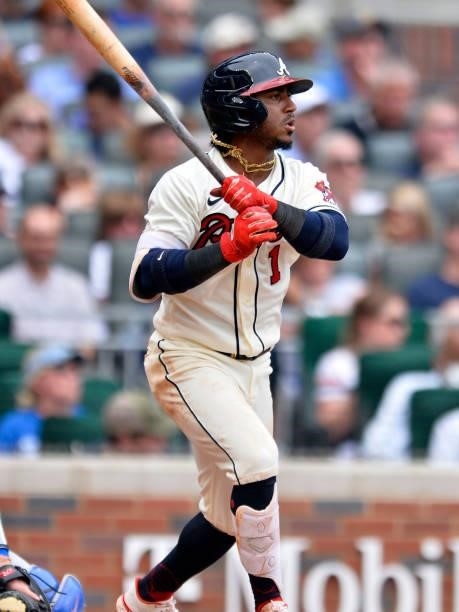 Ozzie Albies of the Atlanta Braves makes a base hit to score Freddie Freeman in the bottom of the 3rd inning against the Los Angeles Dodgers at...