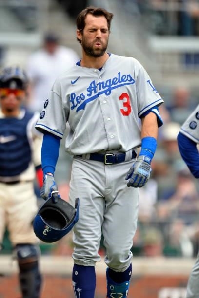 Chris Taylor of the Los Angeles Dodgers winces after taking a foul tip on the shin in the top of the 4th inning against the Atlanta Braves at Truist...