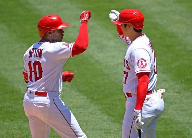 Justin Upton is greeted by Shohei Ohtani of the Los Angeles Angels after hitting a solo home run in the first inning of the game against the Seattle...