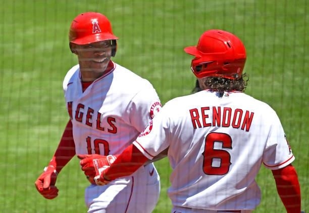 Justin Upton is greeted by Anthony Rendon of the Los Angeles Angels after hitting a solo home run in the first inning of the game against the Seattle...