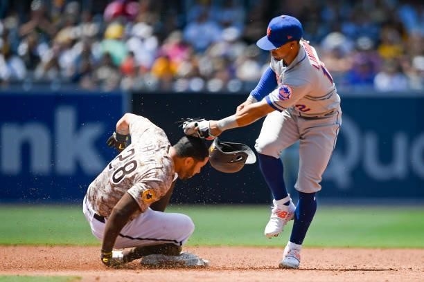 Francisco Lindor of the New York Mets tags Tommy Pham of the San Diego Padres on the head as he steals second base during the third inning of a...