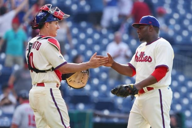 Catcher J.T. Realmuto and closer Hector Neris of the Philadelphia Phillies congratulate each other after the final out in the ninth inning of a game...