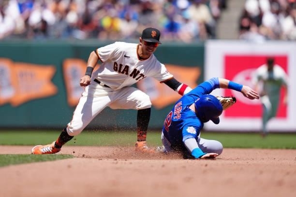 Mauricio Dubón of the San Francisco Giants attempts to tag out Ian Happ of the Chicago Cubs during the game between the Chicago Cubs and the San...