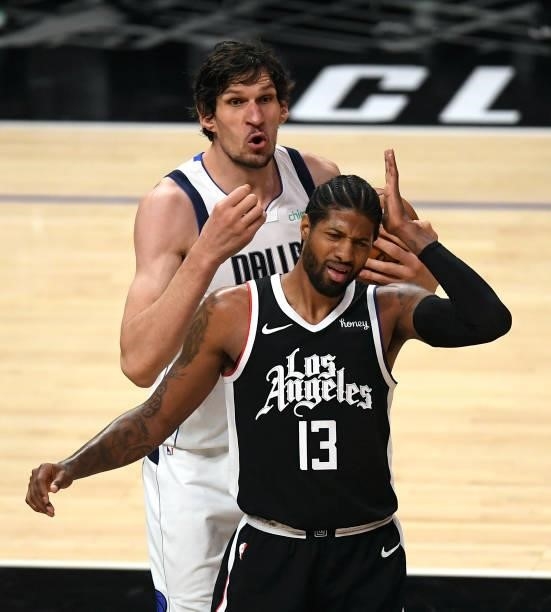Paul George of the Los Angeles Clippers holds hushed after a foul by Boban Marjanovic of the Dallas Mavericks during the first half of Game Seven of...