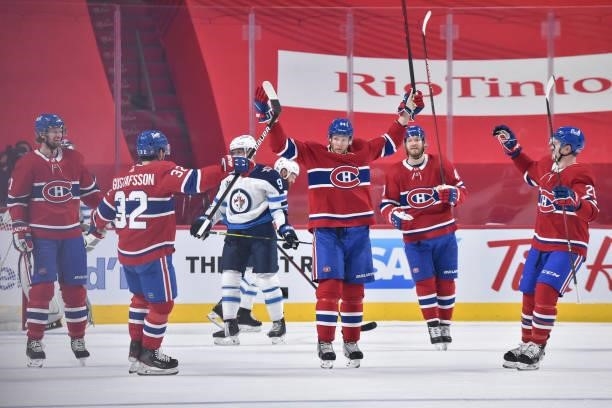 Corey Perry of the Montreal Canadiens raises his arms in celebration with teammate after his goal against the Winnipeg Jets in the first period of...