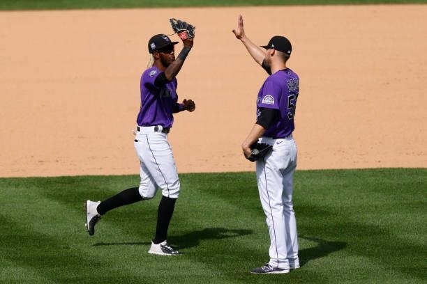 Raimel Tapia and Daniel Bard of the Colorado Rockies celebrate a 3-1 win against the Oakland Athletics at Coors Field on June 6, 2021 in Denver,...