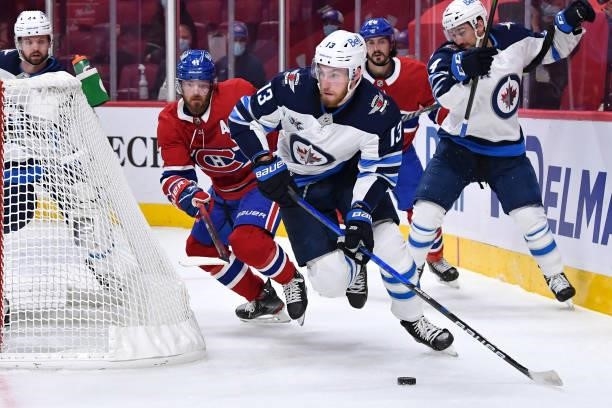 June 6: Pierre-Luc Dubois of the Winnipeg Jets looks to pass the puck followed by Paul Byron of the Montreal Canadiens in Game Three of the Second...