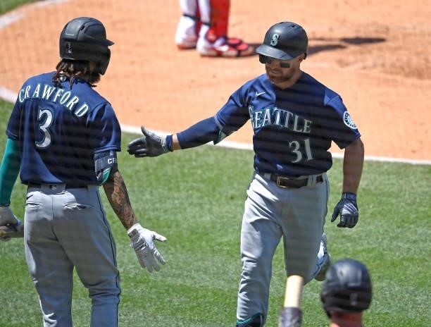 Donovan Walton is greeted by J.P. Crawford of the Seattle Mariners after hitting a solo home run in the third inning of the game against the Los...