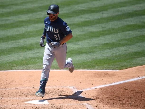 Donovan Walton of the Seattle Mariners crosses the plate after hitting a solo home run in the third inning of the game against the Los Angeles Angels...