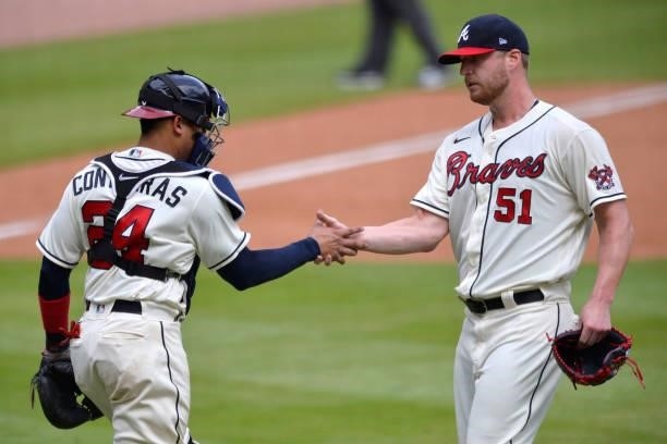 William Contreras and Will Smith of the Atlanta Braves shake hands after beating the Los Angeles Dodgers 4-2 at Truist Park on June 6, 2021 in...