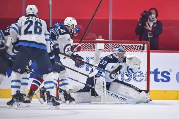 Connor Hellebuyck of the Winnipeg Jets allows a goal in the first period against the Montreal Canadiens in Game Three of the Second Round of the 2021...