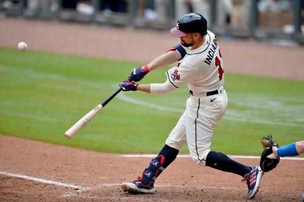 Ender Inciarte of the Atlanta Braves hits a fly ball in the 8th inning to score Guillermo Heredia against the Los Angeles Dodgers at Truist Park on...
